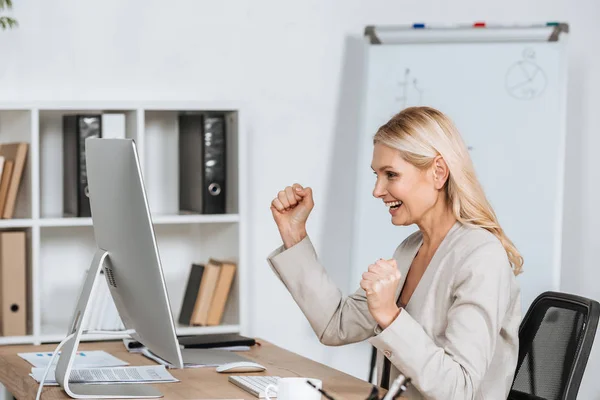 Cheerful Mature Businesswoman Triumphing Using Desktop Computer Workplace — Stock Photo, Image