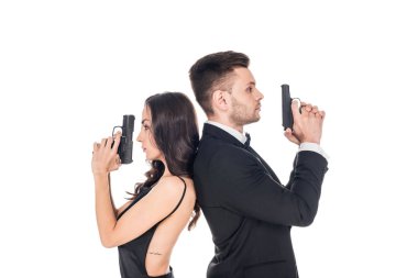 attractive couple of secret agents in black clothes posing with weapon, isolated on white clipart