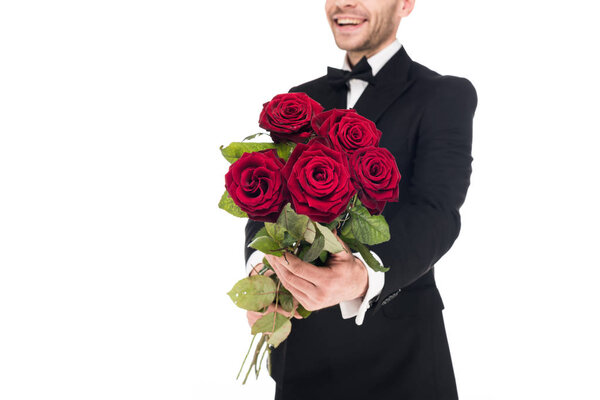 cropped view of happy man gifting red roses for valentines day, isolated on white