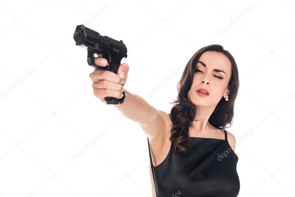 beautiful secret agent aiming with gun isolated on white