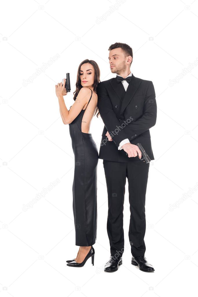 couple of killers in black clothes posing with guns, isolated on white