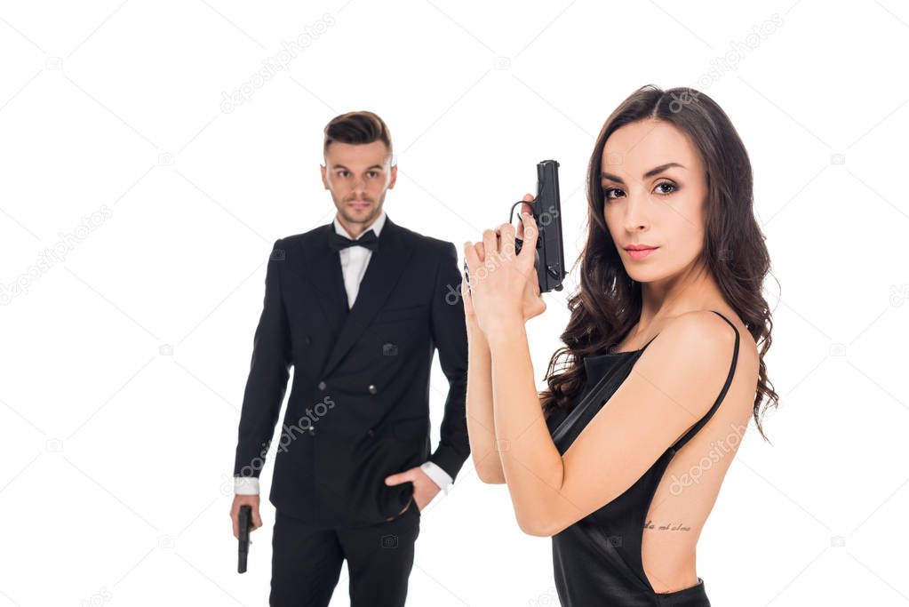 couple of secret agents in black clothes posing with guns, isolated on white
