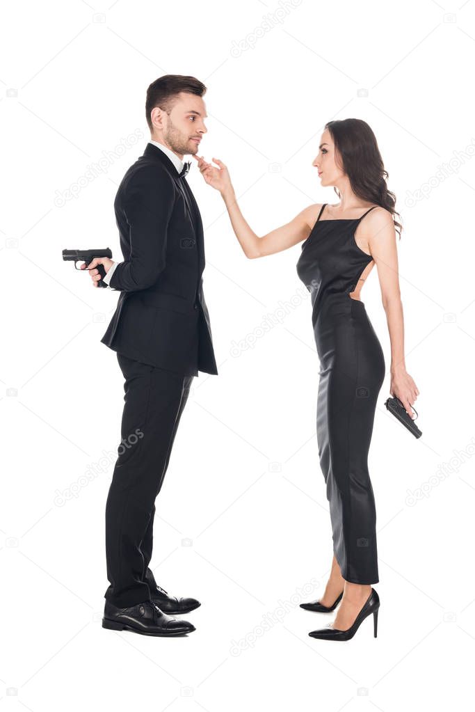 together couple of killers in black clothes holding guns, isolated on white