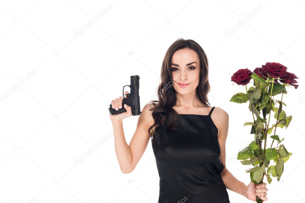 beautiful smiling secret agent holding handgun and red roses, isolated on white