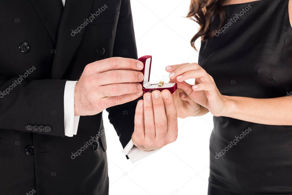 cropped view of boyfriend holding proposal ring in box for girlfriend, isolated on white