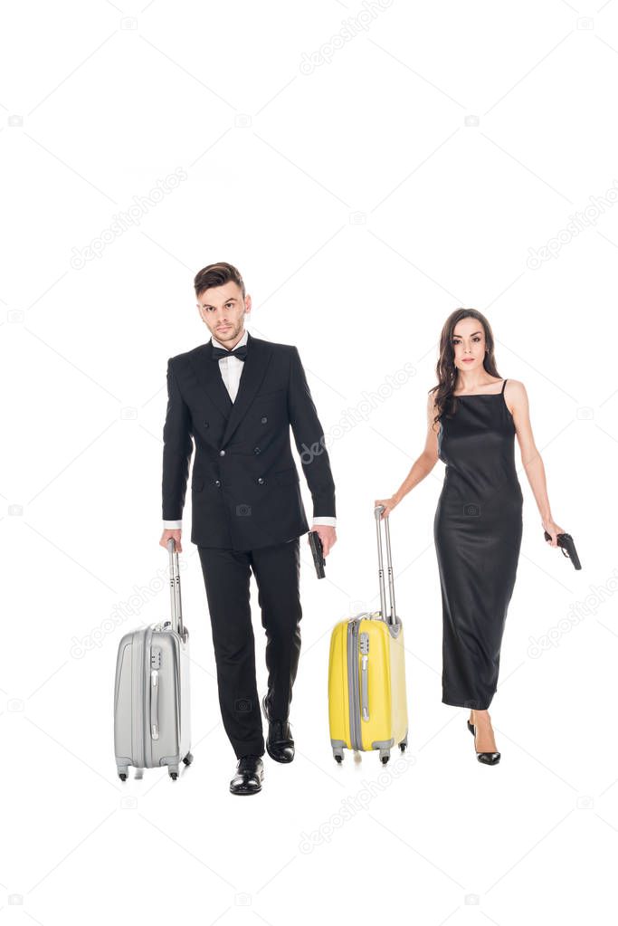 elegant couple of secret agents in black clothes with guns and travel bags, isolated on white