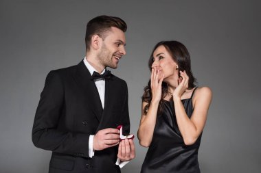 yakışıklı erkek teklif yüzük kutusu gri izole heyecanlı kız için holding