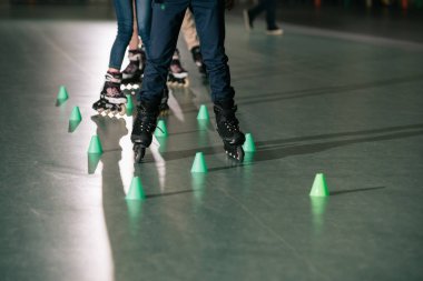 Partial view of kids training on skater rink clipart