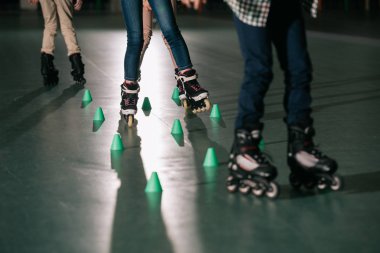 Cropped view of children training on skater rink clipart