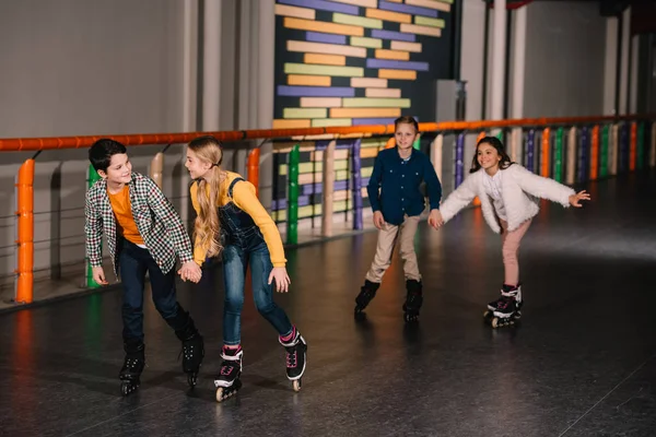 Happy Kids Holding Hands While Training Roller Rink — Stock Photo, Image