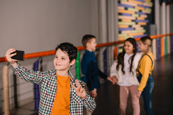 Smiling boy making selfie with best friends