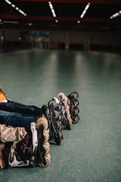 Partial view of children in roller skates resting together