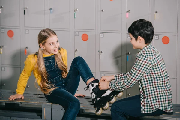 Kid Checkered Shirt Helps Friend Putting Roller Skates — Stock Photo, Image