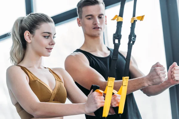Male Trainer Looking Beautiful Sporty Woman Exercising Suspension Straps Gym — Stock Photo, Image
