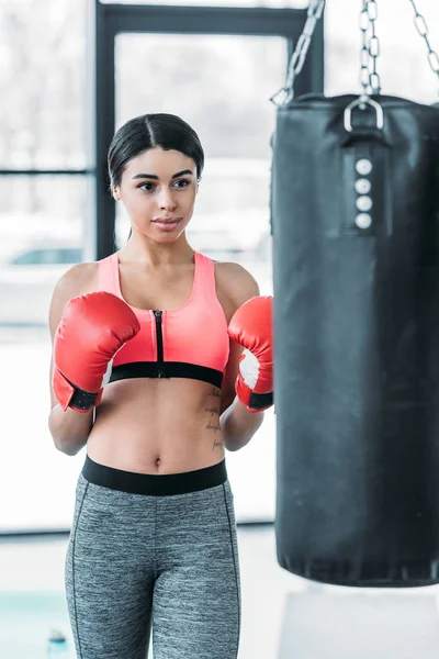 Young African American Sportswoman Boxing Gloves Exercising Punching Bag Gym — 스톡 사진