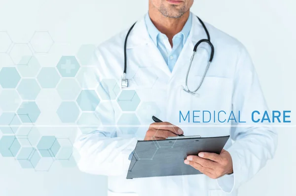 Cropped Image Doctor Stethoscope Shoulders Writing Something Clipboard Isolated White — Stock Photo, Image