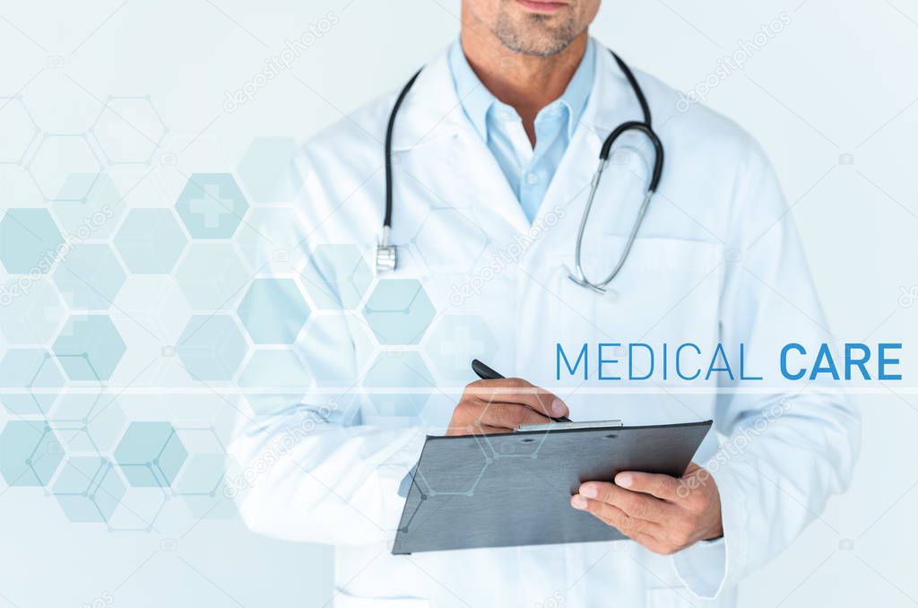 cropped image of doctor with stethoscope on shoulders writing something in clipboard isolated on white with medical care interface