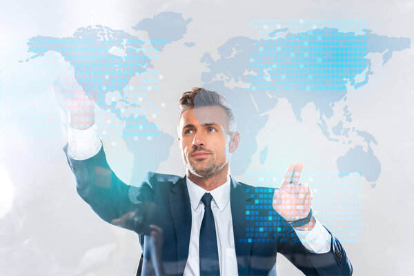 handsome businessman touching innovation technology interface with world map isolated on white, artificial intelligence concept