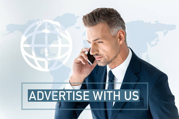 portrait of handsome businessman talking by smartphone isolated on white with map and "advertise with us" lettering  