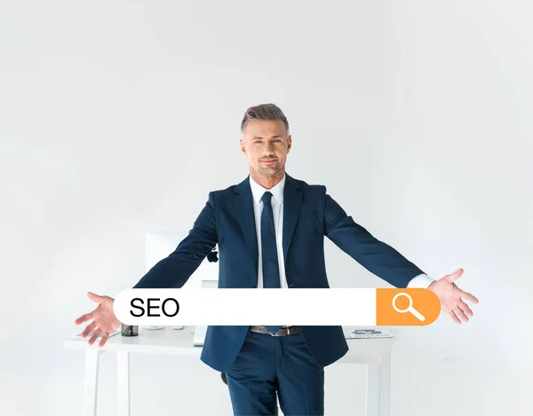 Handsome Businessman Standing Open Arms Table Computer Isolated Grey Seo — Stock Photo, Image