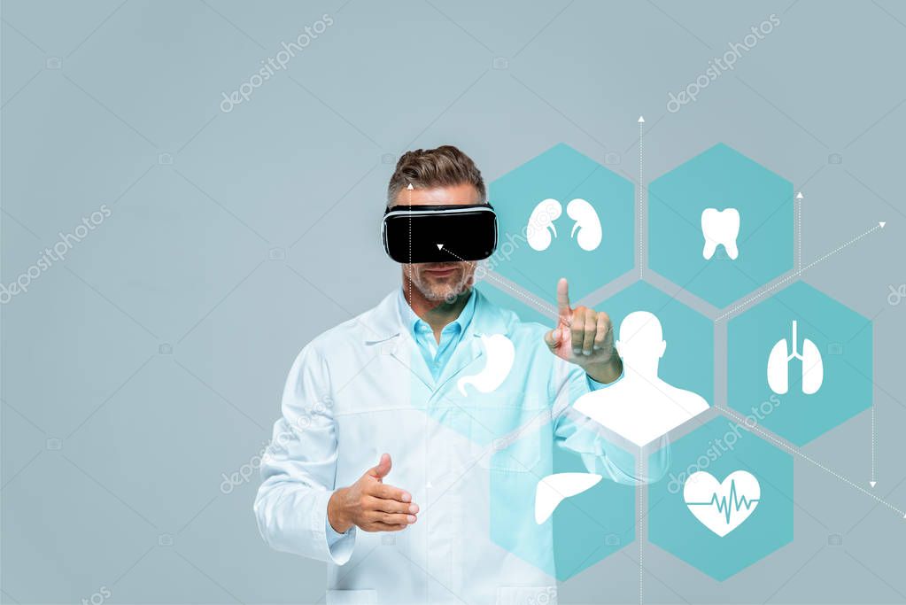 Scientist in virtual reality headset touching medical interface isolated on grey, artificial intelligence concept