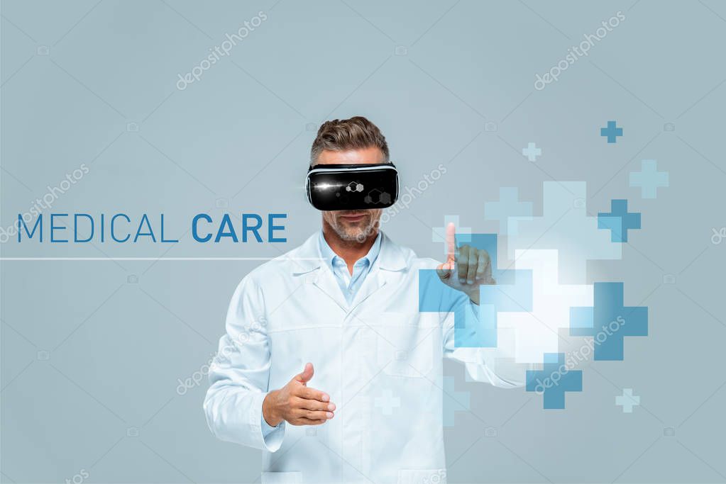 Scientist in virtual reality headset touching medical care interface isolated on grey, artificial intelligence concept