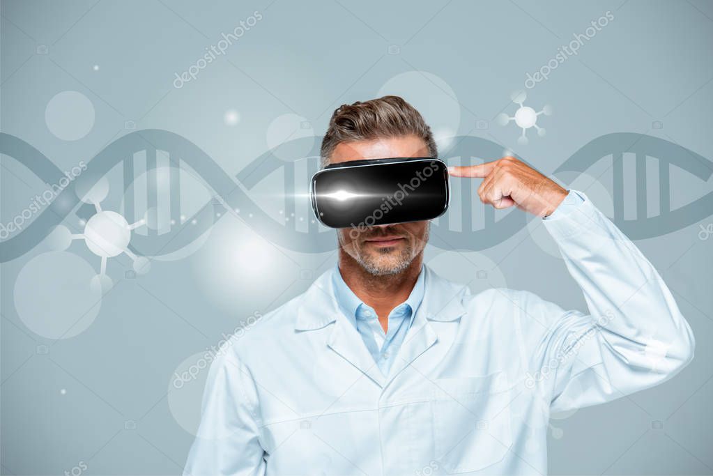 scientist  in virtual reality headset pointing on his head isolated on grey with dna, artificial intelligence concept