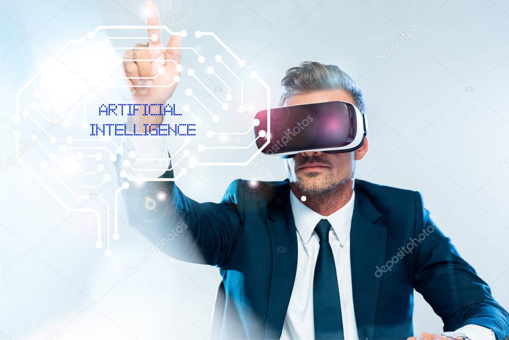 businessman in virtual reality headset touching brain isolated on white, artificial intelligence concept