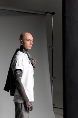 elbise omuz ve uzak studio seyir tutmak yakışıklı dövmeli adam yan görünüm