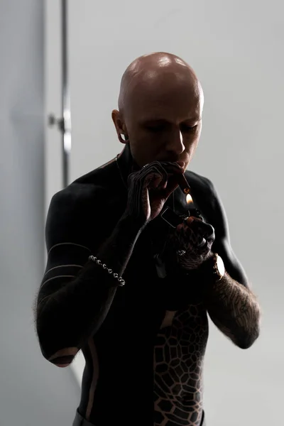 Bare Chested Bald Man Tattoos Holding Lighter Smoking Cigar Grey — Stock Photo, Image