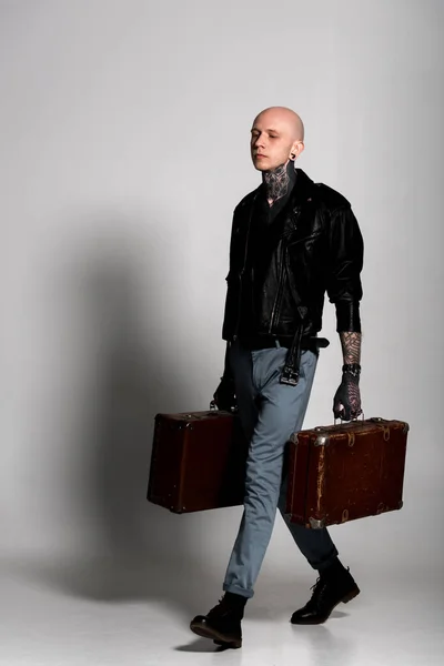 Handsome Tattooed Man Leather Jacket Holding Suitcases Walking Grey — Stock Photo, Image