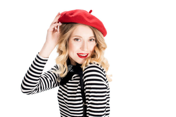 smiling woman holding red beret and smiling isolated on white