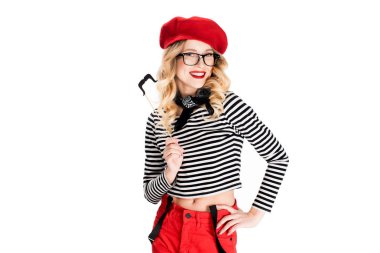 cheerful blonde woman in glasses holding fake mustache on stick isolated on white 