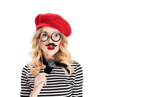 surprised woman with fake mustache on face holding stick with glasses isolated on white