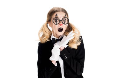 shocked blonde clown holding fake glasses on stick isolated on white 