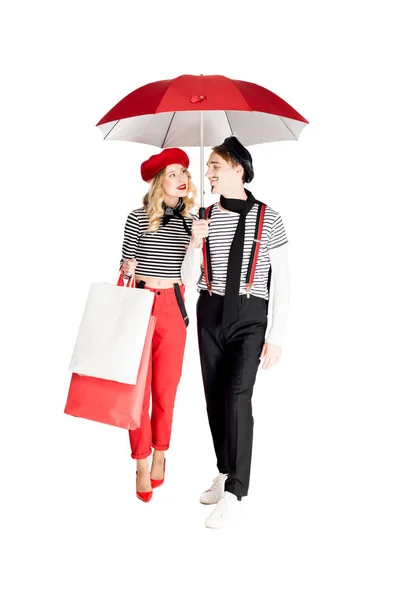 Cheerful Woman Holding Shopping Bags Looking Boyfriend While Standing Umbrella — Stock Photo, Image