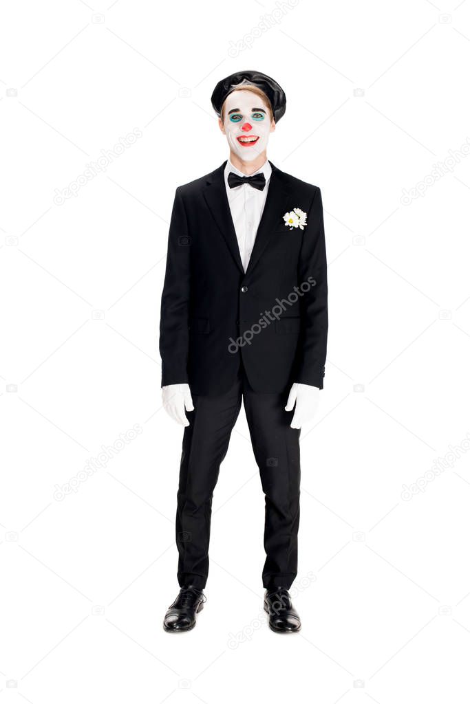 cheerful clown in black beret and suit smiling isolated on white 