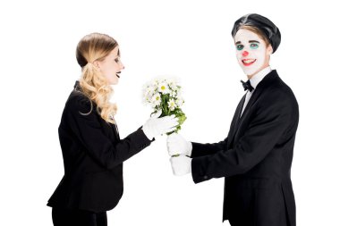 smiling clown giving bouquet to woman isolated on white  clipart