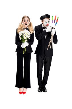 crazy clown looking at firecrackers near woman with flowers isolated on white  clipart