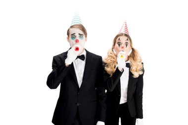 couple of clowns in suits blowing in birthday blowers isolated on white  clipart