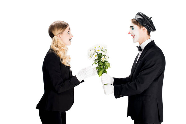 cheerful clown giving bouquet to woman isolated on white 