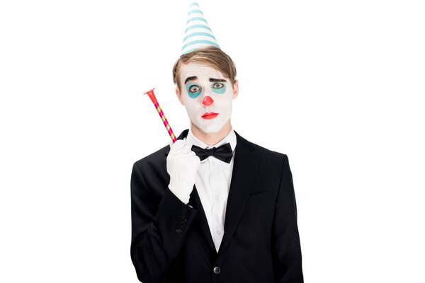 clown in suit and birthday cap holding blower isolated on white 