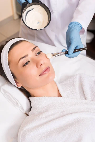 Kosmetolog Tillämpa Kosmetiska Mask Kvinna Kind Med Kosmetiska Borste Skönhetssalong — Stockfoto