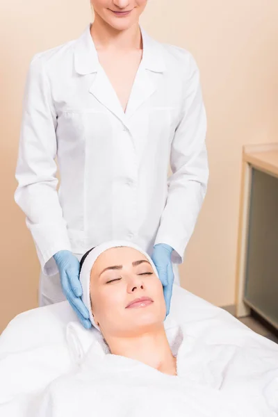 Kosmetolog Som Står Bakom Kvinnan Massagebänk Skönhetssalong — Stockfoto