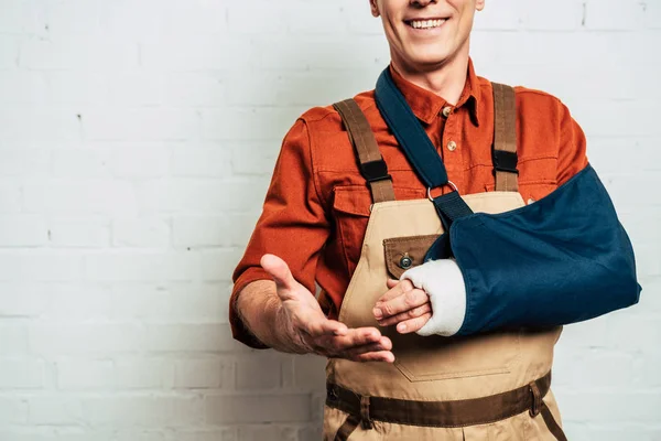 Cropped View Repairman Arm Bandage Standing White Textured Background — Stock Photo, Image