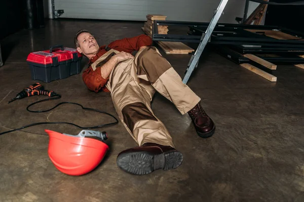 Repairman Lying Floor Uniform Ladder Holding Side Garage — Stock Photo, Image