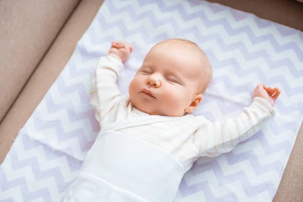 Adorable Baby Closed Eyes Raised Hands Lying Couch — Stock Photo, Image