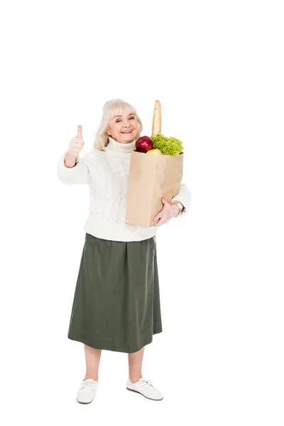 Cheerful Senior Woman Holding Paper Bag Groceries Showing Thumb Isolated — Stock Photo, Image