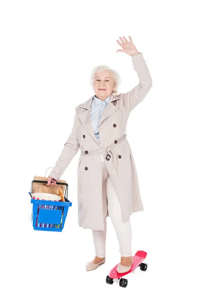 Happy Senior Woman Holding Shopping Basket Waving Hand While Riding — Stock Photo, Image