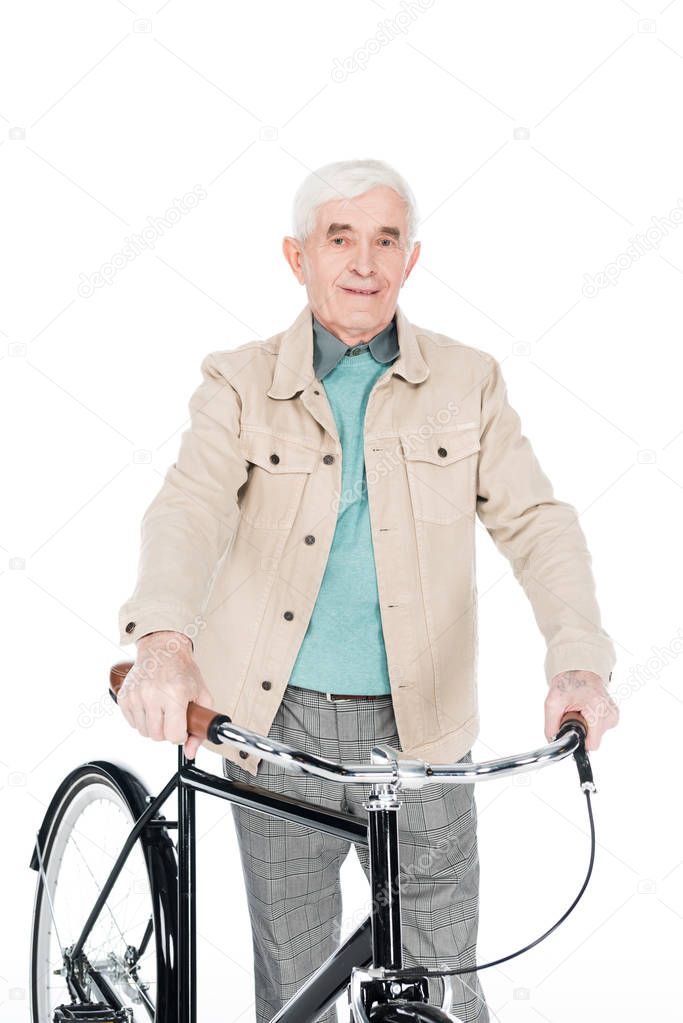 smiling retired man holding bike isolated on white